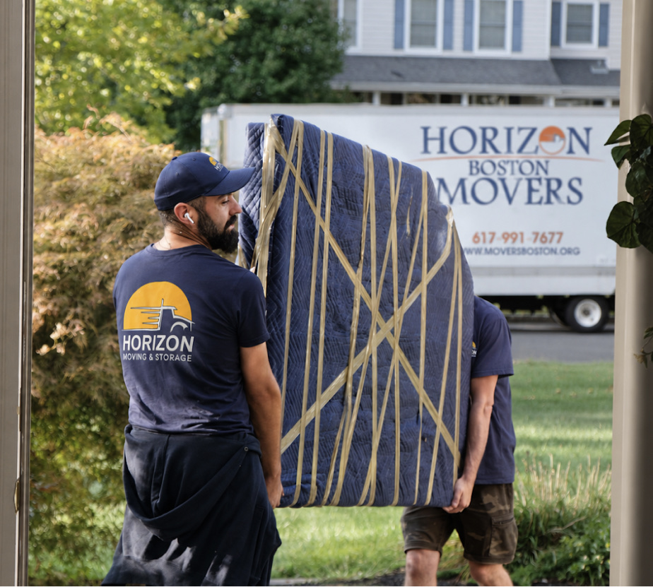 Horizon Boston Movers crew member carrying a wrapped item